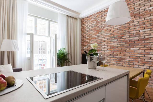 a kitchen with a counter and a brick wall at Wishlist Old Prague Residences - Dlouhá in Prague