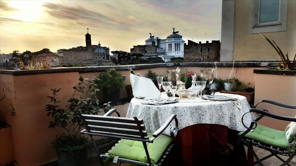 a table on a balcony with a view of the city at Colosseum Colosseo in Rome