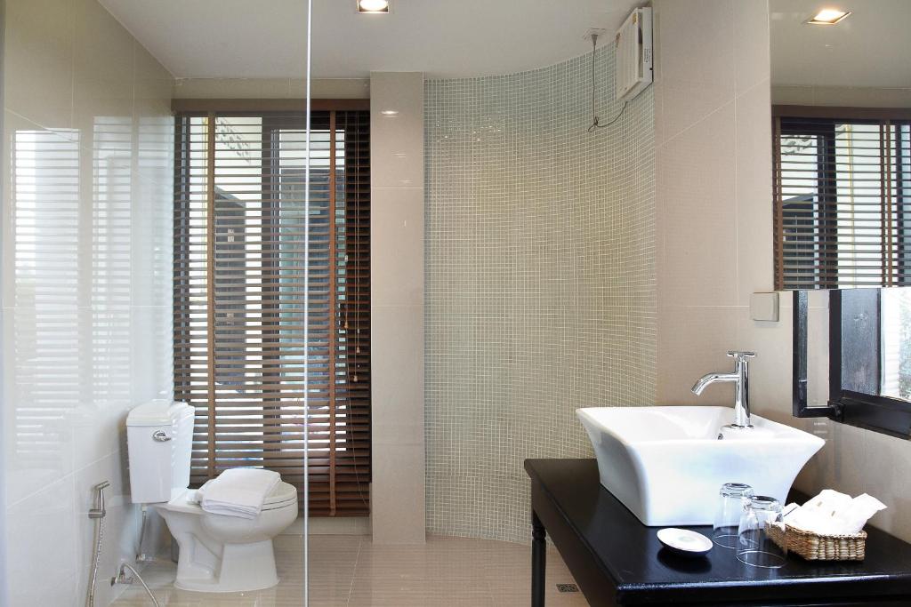 a bathroom with a sink and a toilet at L'air Du Pran in Pran Buri