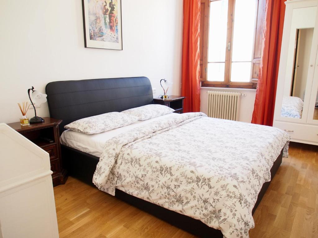 a bedroom with a bed with a white comforter at Eco Pisa Tower Guesthouse in Pisa