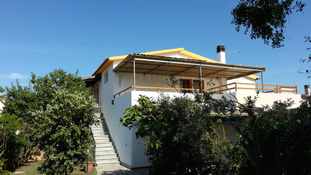 a white house with stairs leading up to it at Sole&Luna in San Teodoro