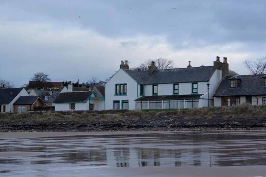 a house on the shore of a body of water at Caledonian House in Portmahomack