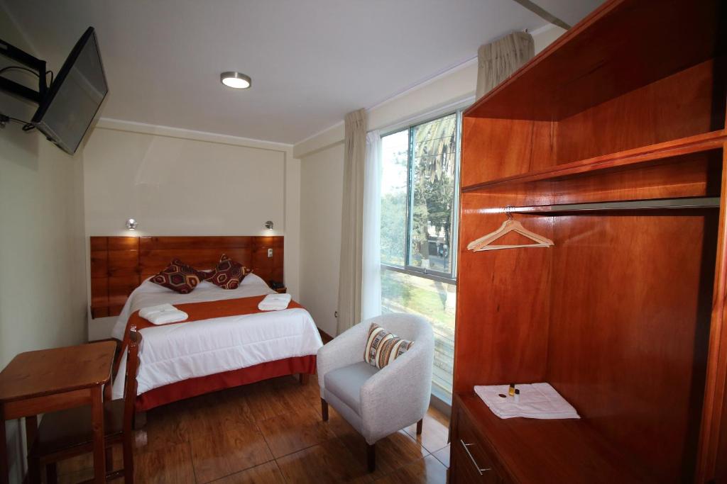 Postel nebo postele na pokoji v ubytování Munayki Hotel