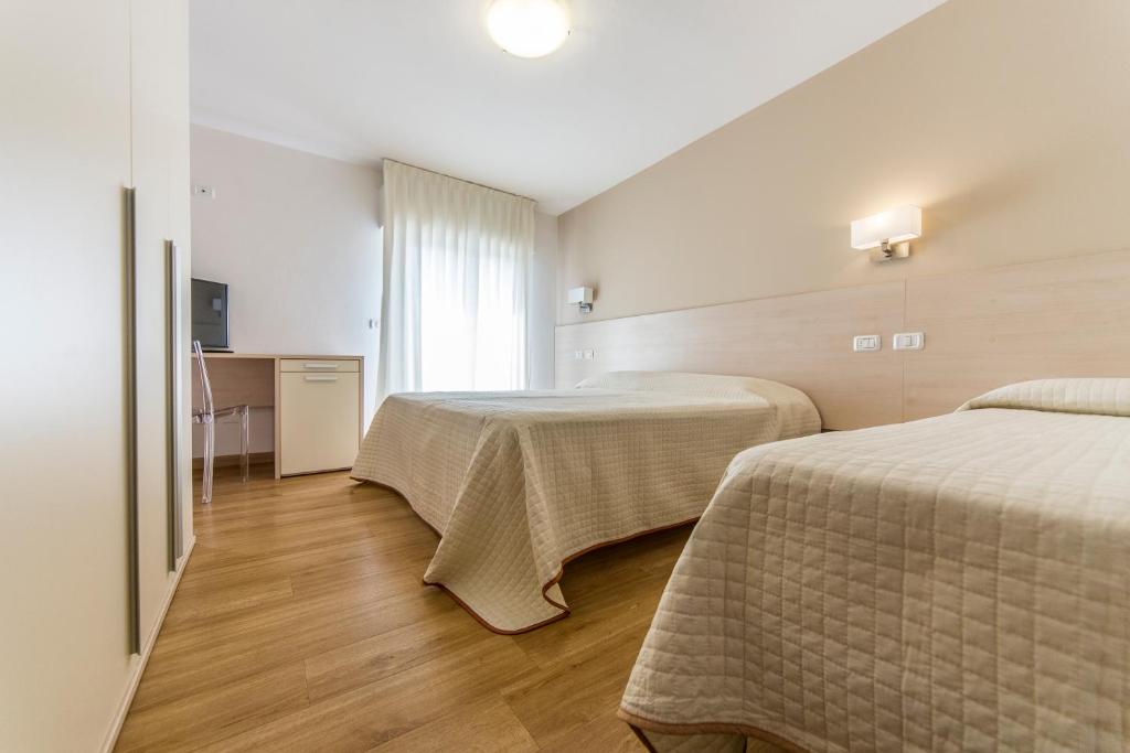 Postel nebo postele na pokoji v ubytování Hotel Silvia