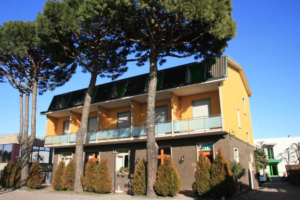 a building with trees in front of it at Albergo Nardini in Lentate sul Seveso