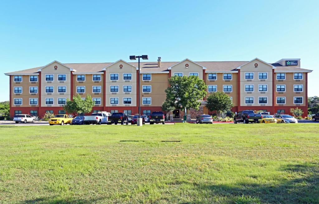 a large building with a lot of windows in the middle of it at Extended Stay America Suites - Austin - Southwest in Austin