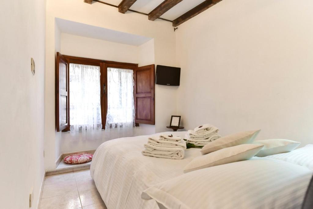 a white room with two beds and a window at Loft Pantheon in Rome