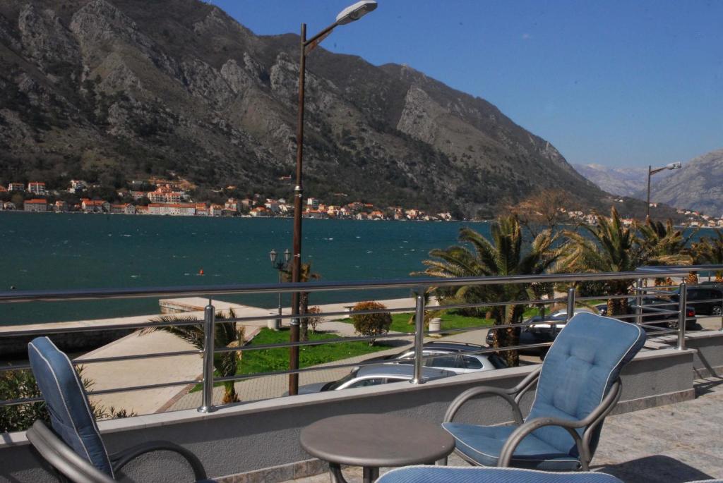a balcony with chairs and a view of a lake at Bjelica Apartments Kotor in Kotor