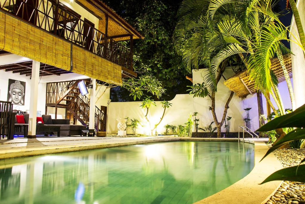 a swimming pool in the middle of a building at Villa Gardenia in Seminyak