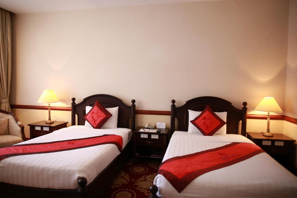 Postel nebo postele na pokoji v ubytování Sammy Dalat Hotel