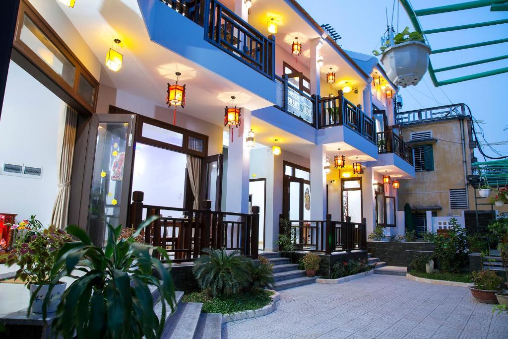 a building with a courtyard with plants and lights at Hoi An Smart Garden Villa in Hoi An