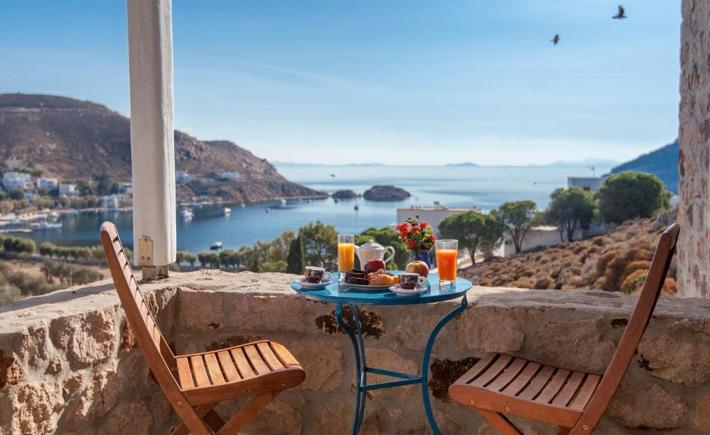 a table with food and drinks on top of a wall at Theologos Houses in Grikos