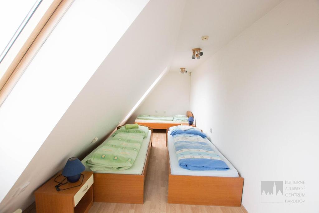 Postel nebo postele na pokoji v ubytování Kulturne Centrum Bardejov