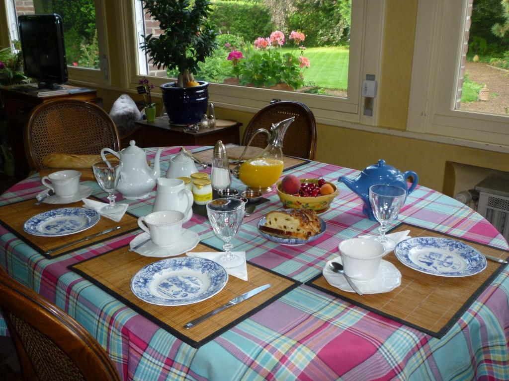 a table with a table cloth with a tea set at au vieux cèdre in Mouvaux