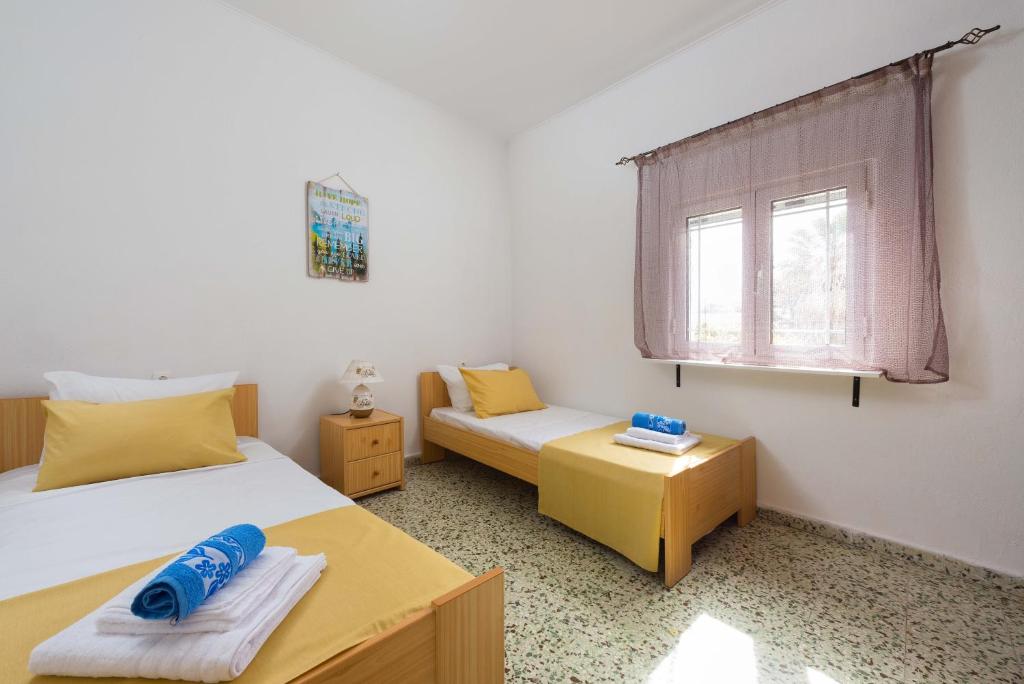 Postel nebo postele na pokoji v ubytování Filerimos House