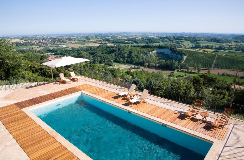 uma piscina com vista para o campo a partir de uma casa em Canonica di Corteranzo em Murisengo