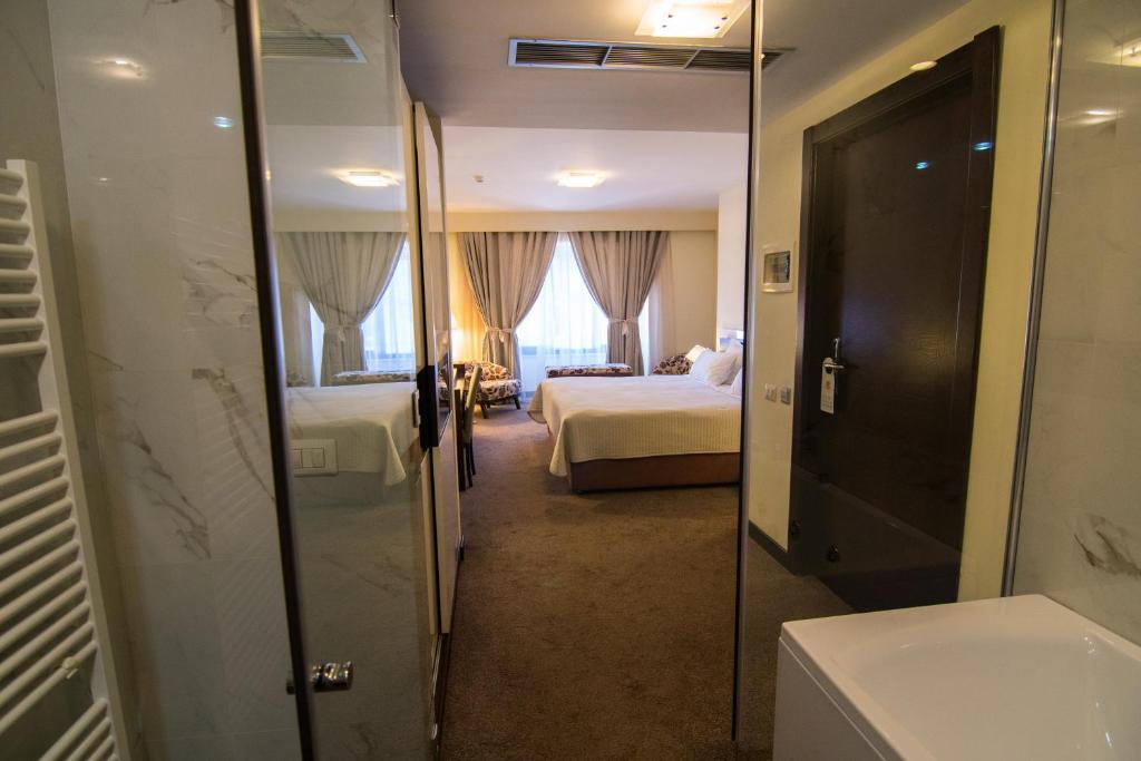 Postel nebo postele na pokoji v ubytování Boutique Hotel Kotoni