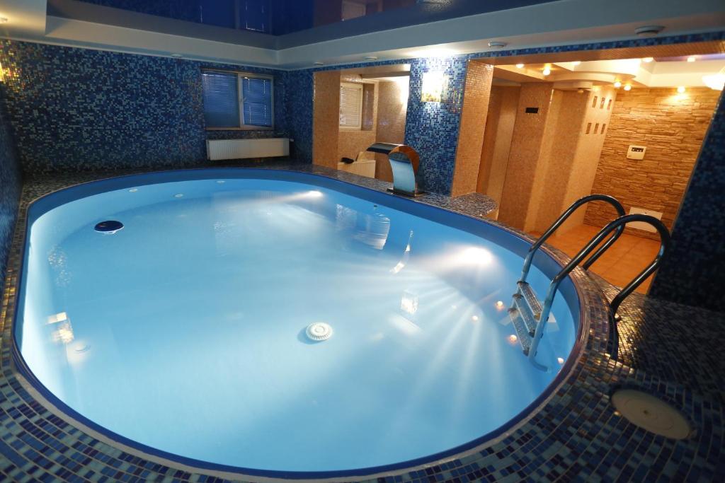 a jacuzzi tub in a bathroom with blue lighting at Tsvit Paporoti in Yaremche