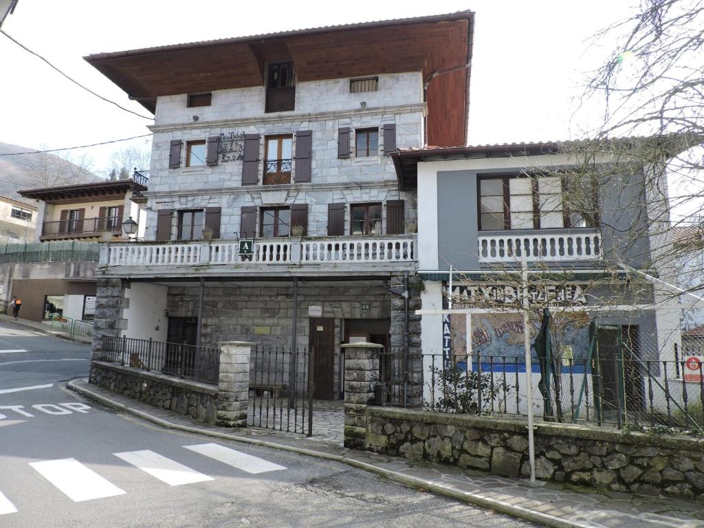 an old white building on the corner of a street at Matxinbeltzenea in Lesaka