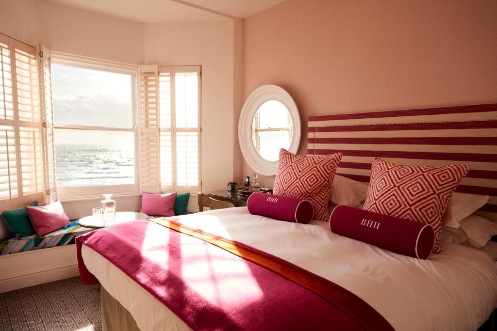 a bedroom with a large bed with a large window at Brighton Harbour Hotel & Spa in Brighton & Hove