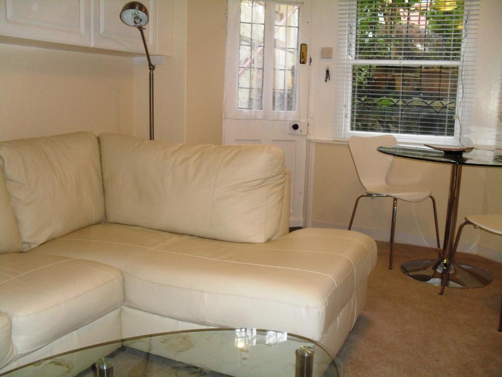 a living room with a white couch and a table at corwen holiday apartment in Llandudno