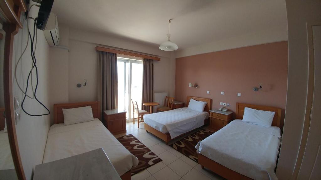 Postel nebo postele na pokoji v ubytování Hotel Lykeon