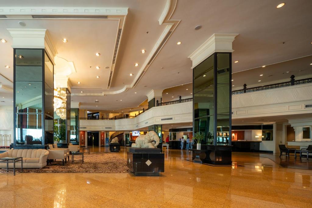 A spacious hotel lobby with a central display and mezzanine level.