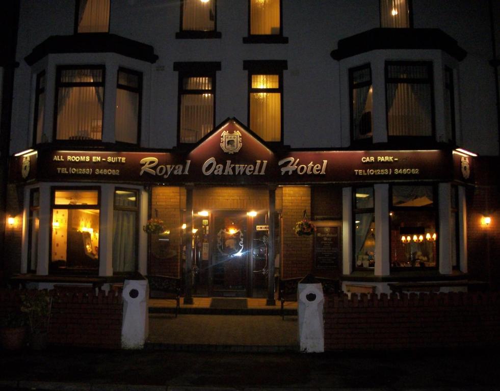 a building with a royal caledonian hotel at night at Royal Oakwell Hotel in Blackpool