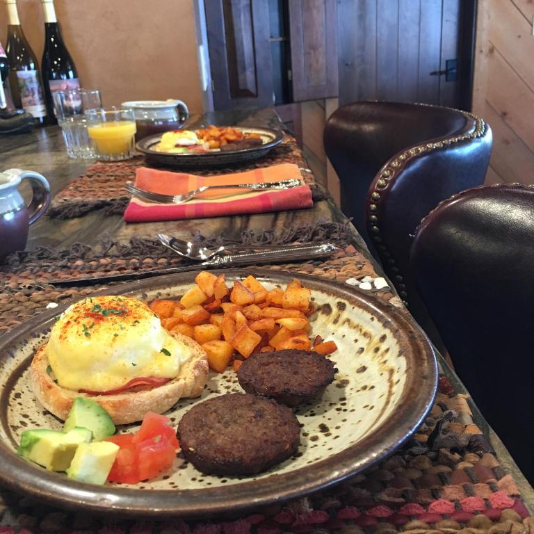 a table with a plate of breakfast food on it at Jackson Hole Hideout in Wilson