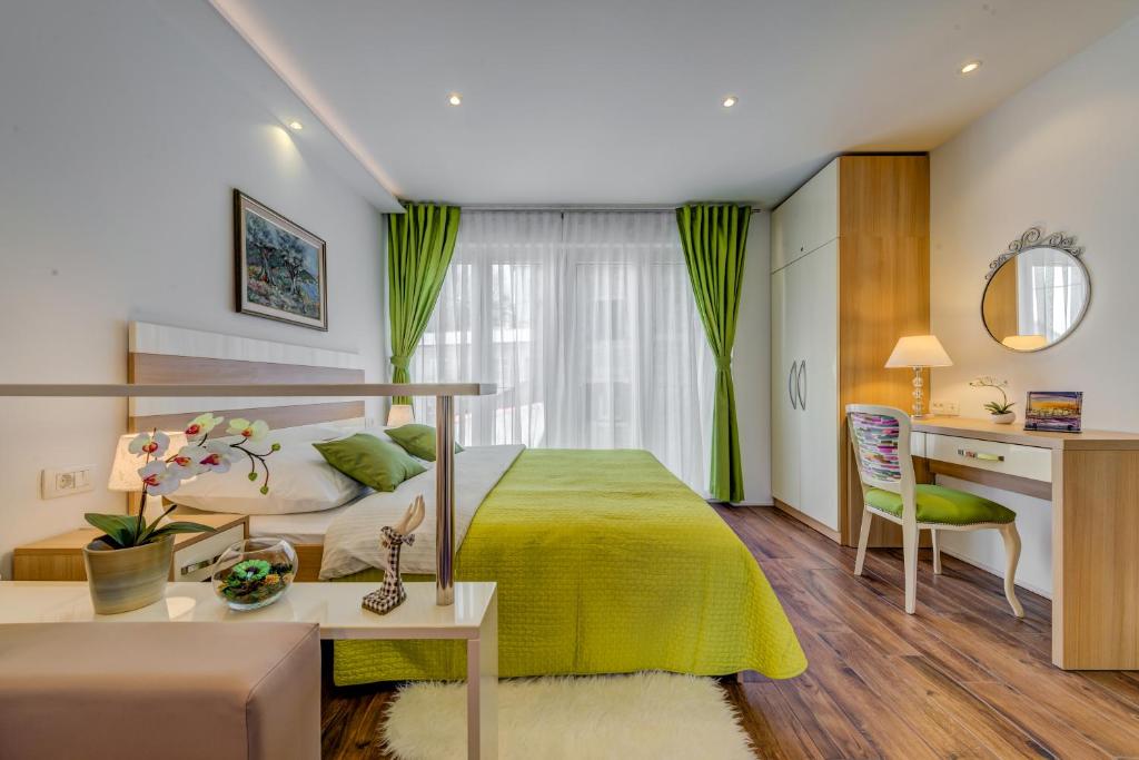 a bedroom with a bed and a desk and a table at Room&studio Apartment Just Enjoy in Split