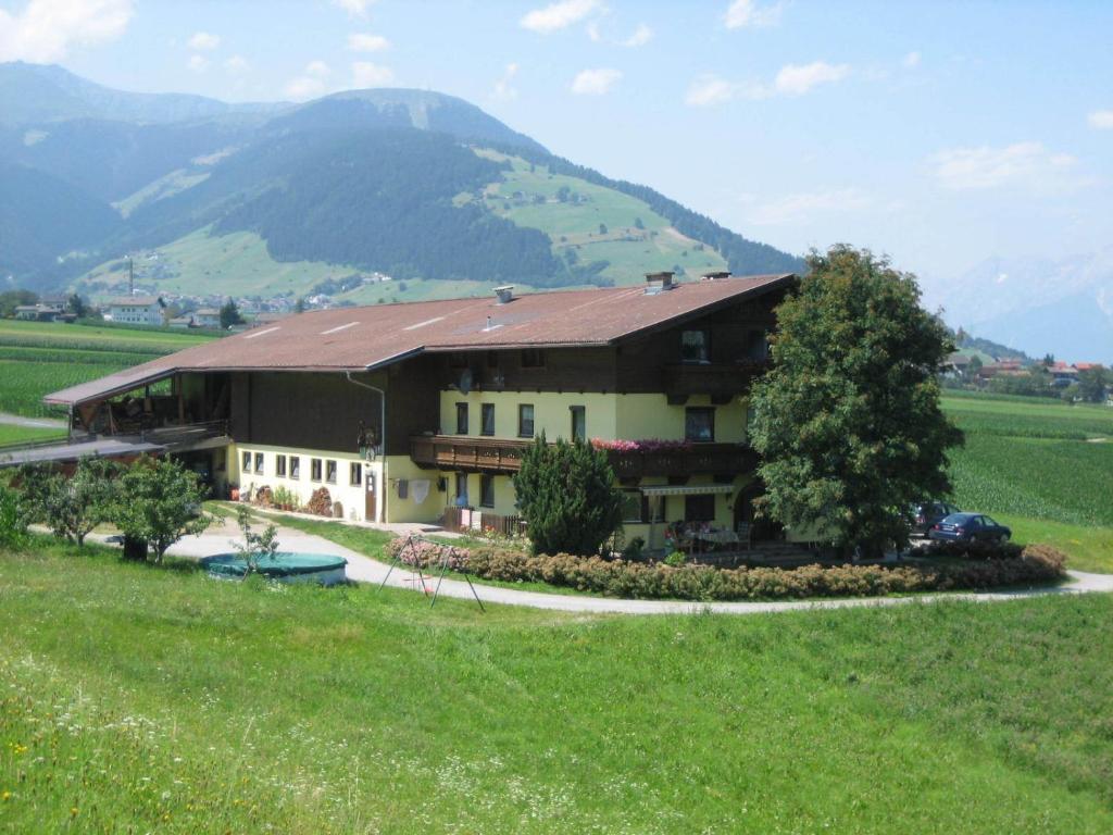 a house in the middle of a green field at Funerhof in Innsbruck