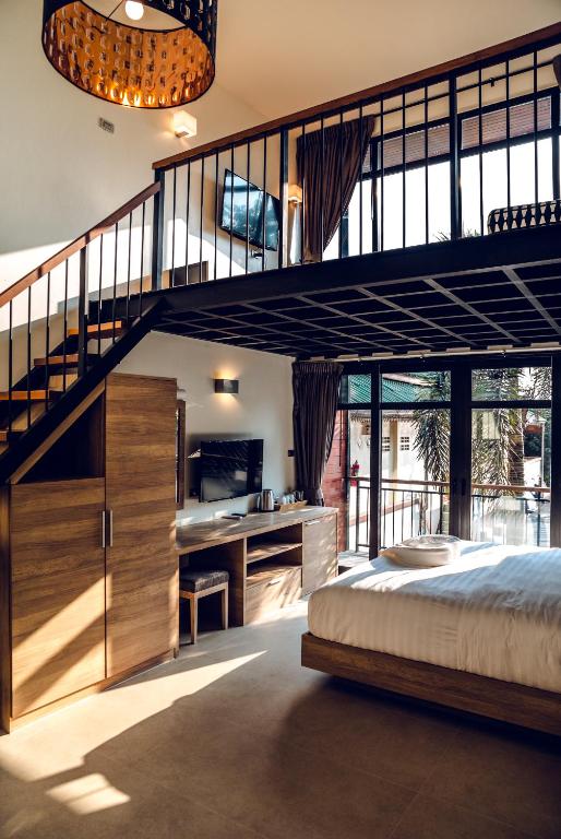 a bedroom with a loft bed and a staircase at 15 Palms Beach Resort in Ko Chang
