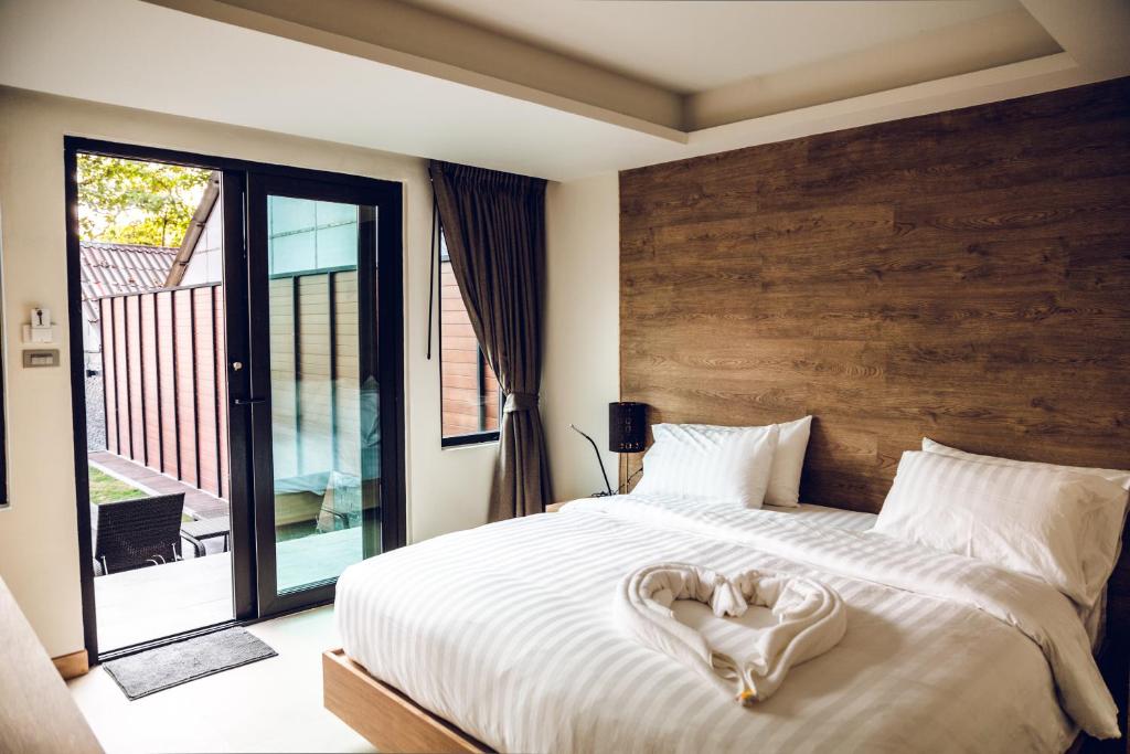 a bedroom with a bed with a heart made up at 15 Palms Beach Resort in Ko Chang