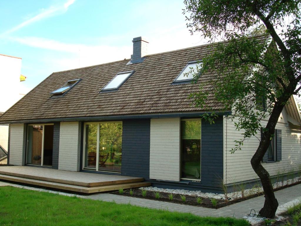 a house with a gambrel roof and a porch at Lembitu Holiday Home in Pärnu