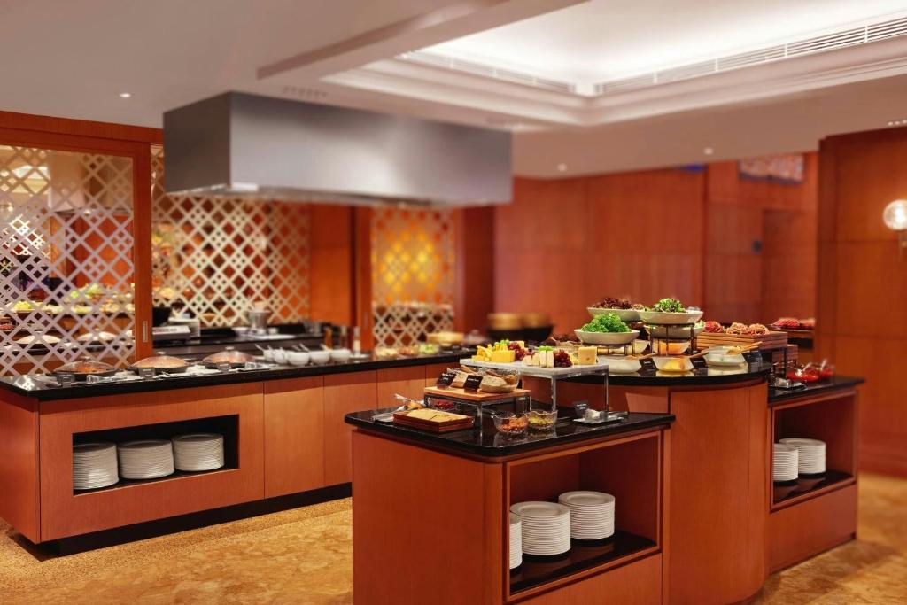 A polished buffet station displaying plated dishes, desserts and serving ware.