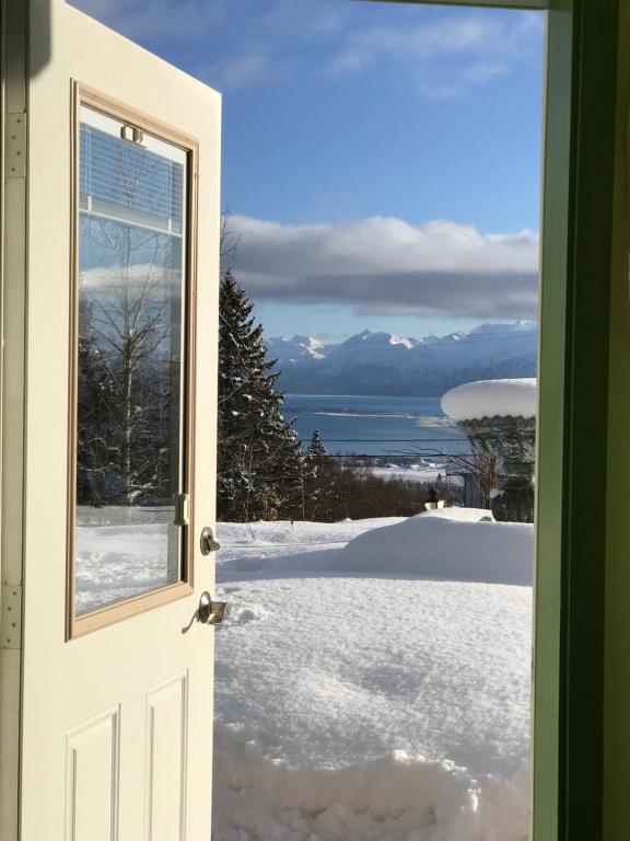 an open door with a view of snow and mountains at Halcyon Heights B&B/Inn in Homer