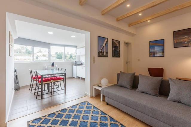 a living room with a couch and a table at Porto Bridges By Living Well in Vila Nova de Gaia