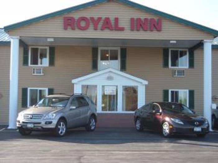 two cars parked in front of a royal inn at Royal Inn Motel in Watertown