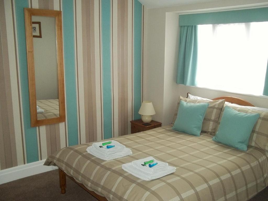 a bedroom with a bed with two trays on it at The Almar in Scarborough