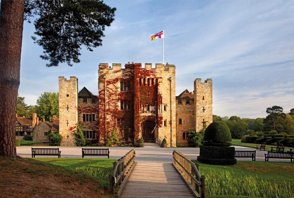 a castle with a flag on top of it at Hever Castle Luxury Bed and Breakfast in Edenbridge