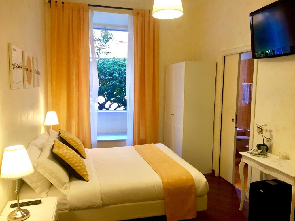 a hotel room with a bed and a window at Dhome B&B in Rome