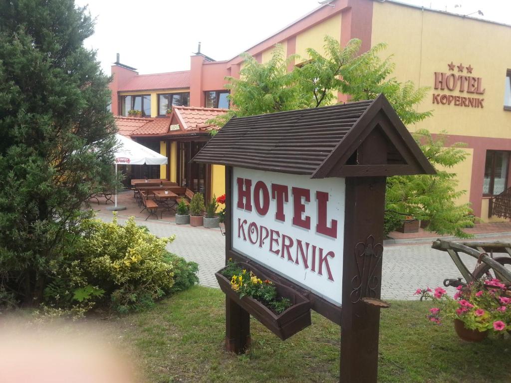 a hotel sign in front of a hotel kerrine at Hotel Kopernik in Frombork