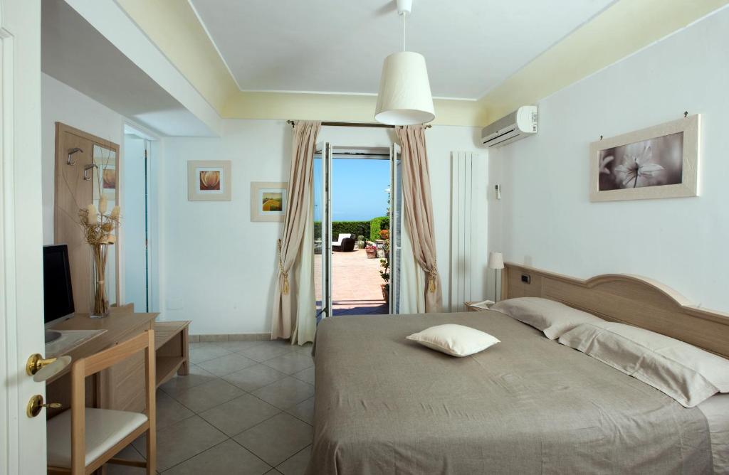 Postel nebo postele na pokoji v ubytování B&B Il Tramonto