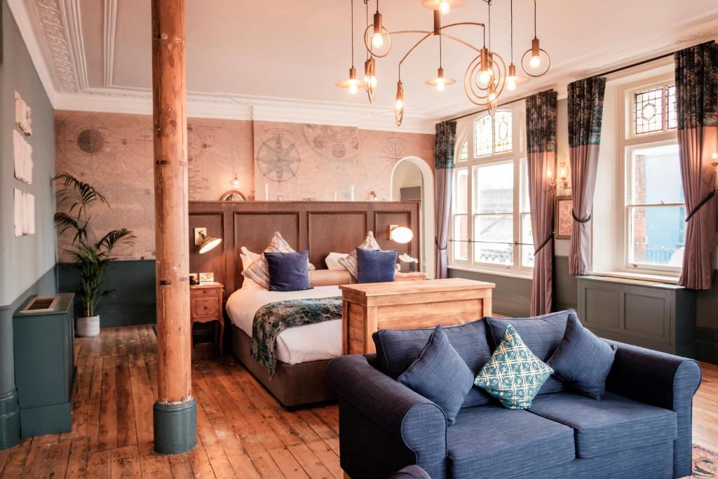 a hotel room with a bed and a couch at Half Moon in London