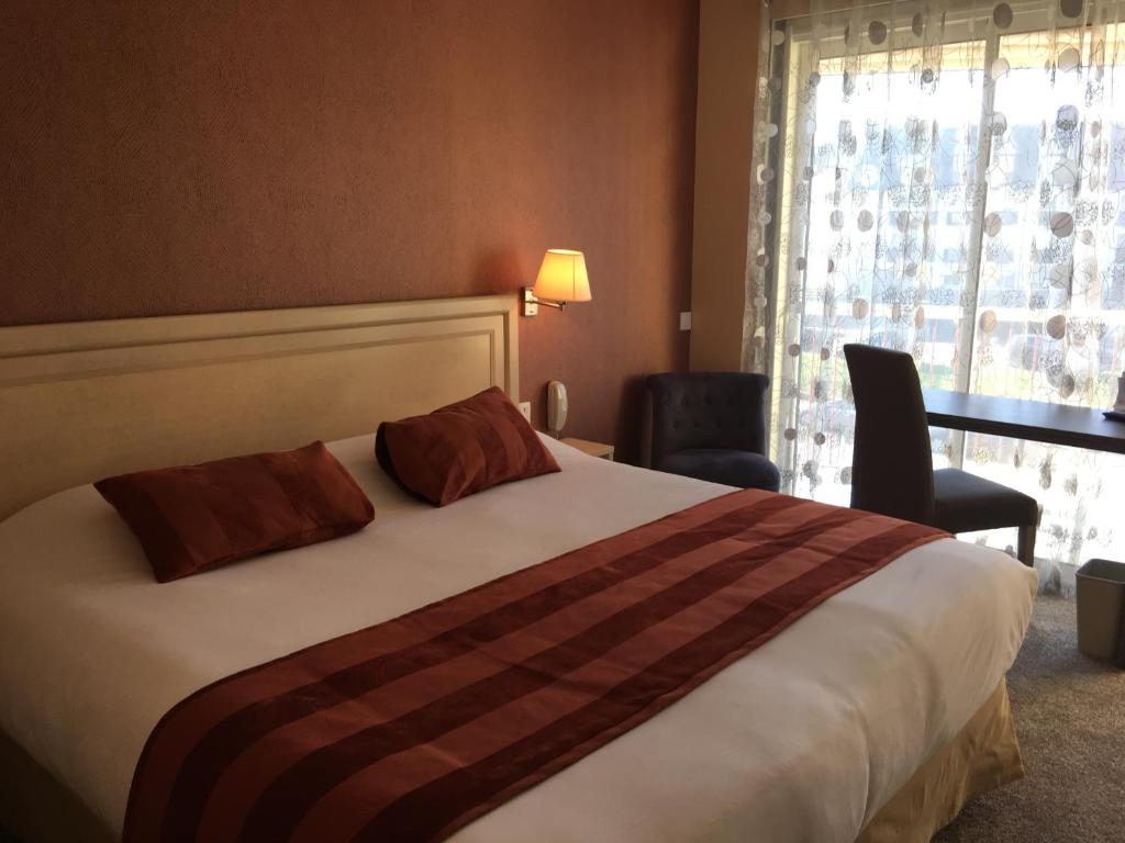 Postel nebo postele na pokoji v ubytování Bagnoles Hotel - Contact Hotel