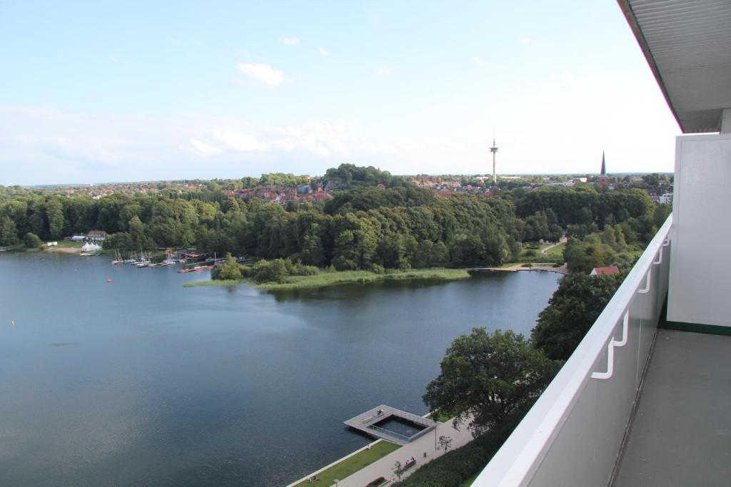 a view of a lake from a balcony at Seeblick Bad Segeberg in Bad Segeberg
