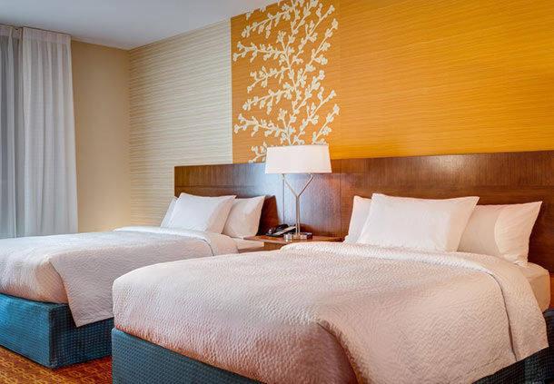 a hotel room with two beds and a lamp at Fairfield Inn & Suites by Marriott Detroit Canton in Canton
