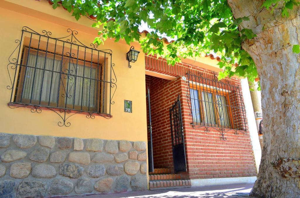 a building with a gate and a brick wall at Hostal Alamo in Cafayate
