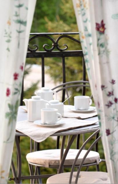 a table with white cups and saucers on it at Pensjonat Mijamar in Białogóra