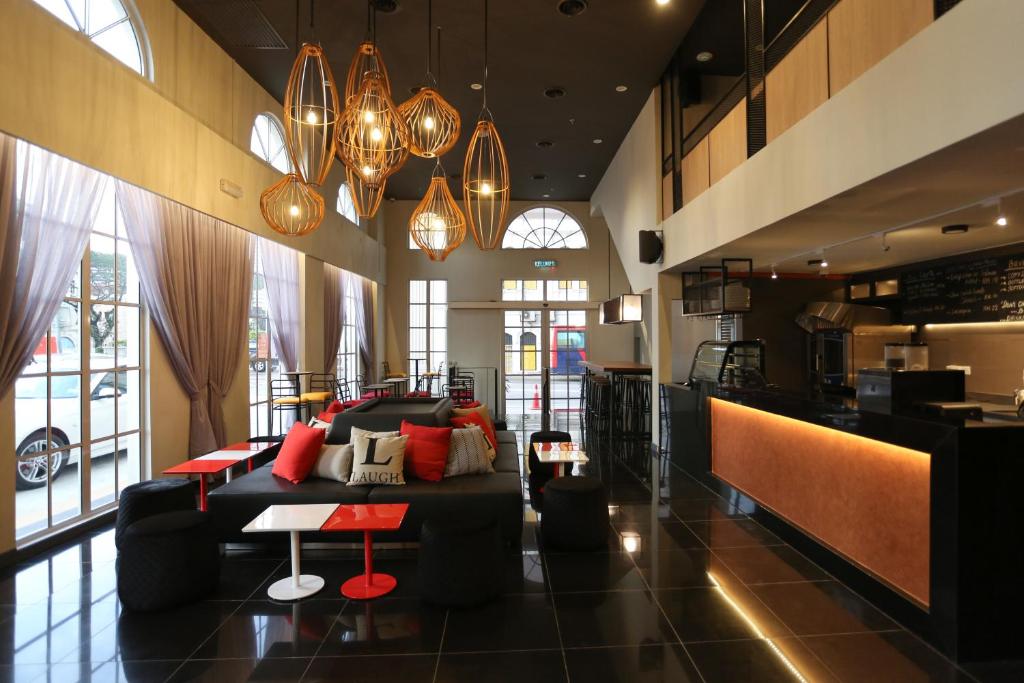 a living room with a couch and a bar at Avenue J Hotel, Central Market in Kuala Lumpur